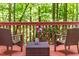 Outdoor deck with furniture overlooking a lush green forest, perfect for relaxation and enjoying nature at 412 Bowen Rd, Rougemont, NC 27572