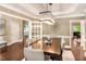 Formal dining room with a large table, modern chandelier, and hardwood floors, creating an inviting space for gatherings at 412 Bowen Rd, Rougemont, NC 27572