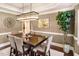 Elegant dining room with a rectangular table, pendant lighting, neutral walls, and a decorative plant, perfect for entertaining at 412 Bowen Rd, Rougemont, NC 27572