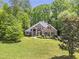 Beautiful two-story brick home surrounded by lush green trees at 412 Bowen Rd, Rougemont, NC 27572