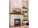 Close up of the white stone fireplace and floating shelves in a living room at 412 Bowen Rd, Rougemont, NC 27572