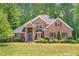 Stately brick home featuring a manicured lawn and mature landscaping at 412 Bowen Rd, Rougemont, NC 27572