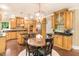Kitchen and dining area with wood cabinets, stainless steel appliances, and granite countertops at 412 Bowen Rd, Rougemont, NC 27572