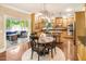 Spacious kitchen and dining area featuring wood cabinets and access to a screened porch at 412 Bowen Rd, Rougemont, NC 27572