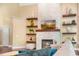 Bright living room featuring a modern fireplace with floating shelves at 412 Bowen Rd, Rougemont, NC 27572
