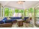 Cozy screened porch with a comfortable seating area and a view of the trees at 412 Bowen Rd, Rougemont, NC 27572