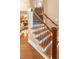 Elegant staircase with wood and metal railings, leading to the upper level of the home; hardwood floors and neutral walls at 412 Bowen Rd, Rougemont, NC 27572