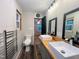 Bright bathroom featuring double sink vanity and toilet; opens into bedroom at 4501 Rockwood Dr, Raleigh, NC 27612