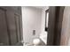 A well lit bathroom with white basin sink, toilet, and dark cabinets at 4501 Rockwood Dr, Raleigh, NC 27612