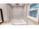 Bathroom features a tiled walk-in shower, bathtub, and window at 4501 Rockwood Dr, Raleigh, NC 27612