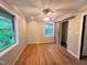 Bedroom features a ceiling fan, multiple windows for natural light, and wood floors at 4501 Rockwood Dr, Raleigh, NC 27612