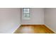 Bedroom with hardwood flooring and a large window at 4501 Rockwood Dr, Raleigh, NC 27612