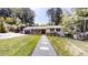 Inviting single-story home with a well-manicured lawn and charming front walkway at 4501 Rockwood Dr, Raleigh, NC 27612