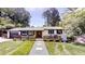 Charming single-story home with a modern black and white exterior and welcoming front porch at 4501 Rockwood Dr, Raleigh, NC 27612