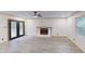 Living room with updated flooring features a brick fireplace, new lighting, and French doors to deck at 4501 Rockwood Dr, Raleigh, NC 27612