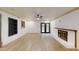 Bright living room features a white brick fireplace and built-in shelving, with a ceiling fan at 4501 Rockwood Dr, Raleigh, NC 27612