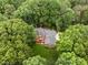 An aerial view of the house shows the brick exterior, large yard, and mature landscaping at 4505 Wood Valley Dr, Raleigh, NC 27613
