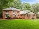 Spacious brick home featuring an expansive lush backyard and wooden deck, perfect for outdoor entertaining at 4505 Wood Valley Dr, Raleigh, NC 27613