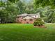 Large, lush backyard with green lawn and mature landscaping at 4505 Wood Valley Dr, Raleigh, NC 27613