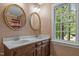 Classic bathroom features double vanity with two large decorative mirrors at 4505 Wood Valley Dr, Raleigh, NC 27613