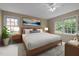 Nicely staged bedroom with ample natural light, a ceiling fan, and stylish décor at 4505 Wood Valley Dr, Raleigh, NC 27613