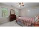Bright bedroom with two windows, a dresser, and a spacious closet at 4505 Wood Valley Dr, Raleigh, NC 27613