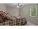 Bright bedroom with large window, ceiling fan, and a comfortable bed at 4505 Wood Valley Dr, Raleigh, NC 27613