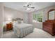 Comfortable bedroom with large window offering a wooded view and rustic furniture at 4505 Wood Valley Dr, Raleigh, NC 27613