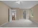 Spacious bedroom provides access to kitchen and features a window and multiple doorways at 4505 Wood Valley Dr, Raleigh, NC 27613