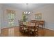 Formal dining room with hardwood floors, chandelier, and view of outside scenery from the window at 4505 Wood Valley Dr, Raleigh, NC 27613