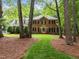 Charming brick home with manicured lawn and mature trees creating a serene and inviting curb appeal at 4505 Wood Valley Dr, Raleigh, NC 27613