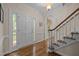 Elegant foyer boasts hardwood floors, a graceful staircase, and a welcoming entrance filled with natural light at 4505 Wood Valley Dr, Raleigh, NC 27613