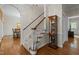 Classic foyer features hardwood floors, a carpeted staircase, and a charming display cabinet at 4505 Wood Valley Dr, Raleigh, NC 27613