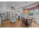 Bright kitchen with white cabinetry, stainless steel appliances, and a breakfast nook with a bay window at 4505 Wood Valley Dr, Raleigh, NC 27613