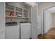 Well-equipped laundry room with washer, dryer, and ample storage shelves at 4505 Wood Valley Dr, Raleigh, NC 27613