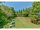 Spacious backyard with playset and lush landscaping at 457 S Greensboro St, Carrboro, NC 27510