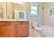 Bathroom with tile floors, wood vanity, and shower-tub combo at 457 S Greensboro St, Carrboro, NC 27510