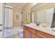Bright and clean bathroom with a shower-tub combination, a large vanity, and neutral tiling at 457 S Greensboro St, Carrboro, NC 27510