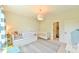 A bedroom with a daybed and crib, and a view of the closet at 457 S Greensboro St, Carrboro, NC 27510
