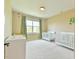 Bright Bedroom featuring two white cribs and a large window at 457 S Greensboro St, Carrboro, NC 27510