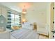 Bedroom with a daybed, crib, large window, and whimsical decor at 457 S Greensboro St, Carrboro, NC 27510