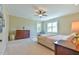 Bright bedroom with a ceiling fan, lots of light and a large dresser at 457 S Greensboro St, Carrboro, NC 27510