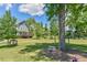 Beautiful community green space with playground, picnic table, and charming homes on a sunny day at 457 S Greensboro St, Carrboro, NC 27510