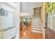 Welcoming entryway with hardwood floors, stairs, and open floor plan at 457 S Greensboro St, Carrboro, NC 27510