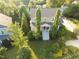 Inviting two-story home with a charming front porch, well-manicured lawn, and mature trees providing ample shade at 457 S Greensboro St, Carrboro, NC 27510