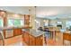 Open floor plan showcasing a kitchen with stainless steel appliances, a dining area, and a view into the living room at 457 S Greensboro St, Carrboro, NC 27510
