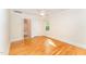 Bright bedroom with hardwood floors, white trim, ceiling fan, and ensuite bathroom and closet at 4832 Brookhaven Dr, Raleigh, NC 27612