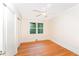A well-lit bedroom with hardwood floors and a closet at 4832 Brookhaven Dr, Raleigh, NC 27612