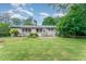 Charming single-story home with a spacious backyard, brick accents, and well-manicured landscaping at 4832 Brookhaven Dr, Raleigh, NC 27612
