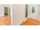 Foyer with hardwood floors, a white front door with an oval window, and an open doorway at 4832 Brookhaven Dr, Raleigh, NC 27612